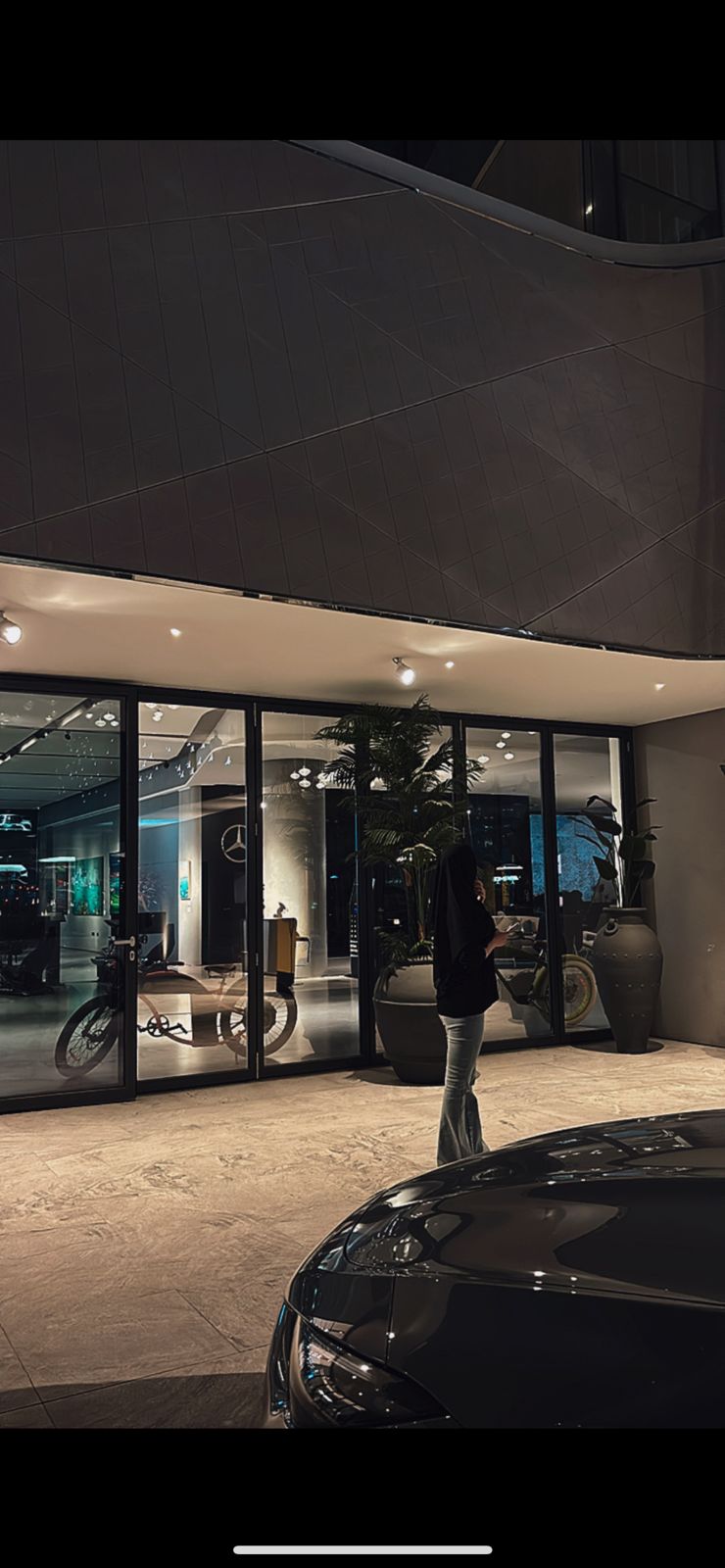 Woman in blue dress with pink fabric backdrop
